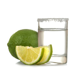 silver tequila in a glass glass with lime close up on a white isolated background