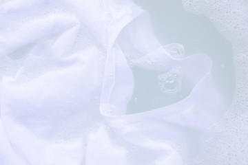 Obraz na płótnie Canvas Soak cloth before washing, white t-shirt