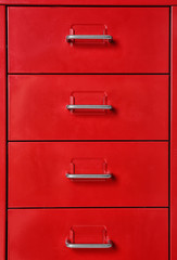 Red wardrobe drawers as background, closeup view