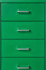 Green wardrobe drawers as background, closeup view