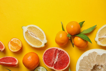 Different citrus fruits on color background, top view. Space for text