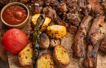 restaurant menu. Big juicy grilled beef steak close up. grilled corn and tomatoes with potatoes. unhealthy diet. overcooked food