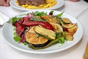 Fresh grilled vegetables on white plate, tasty and healthy lunch