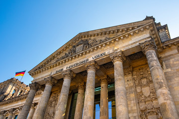 Berlin, Germany - Front view of the historic Reichstag building facade with the monumental colonnade and To The German People - Dem Deutschen Volke - inscription