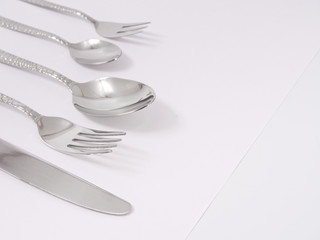silverware forks spoons knives cutlery on a white background
