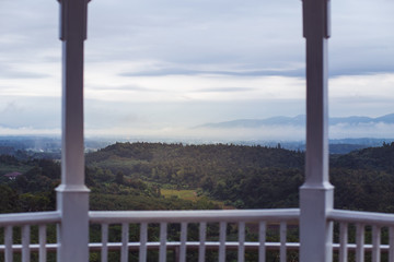 Wooden balcony overlooking the white mist mountain