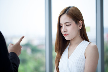 young beautiful employee so sad was blame by boss and finger pointing to she .scolding .
