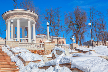 winter in urban park,white gazebo on the top