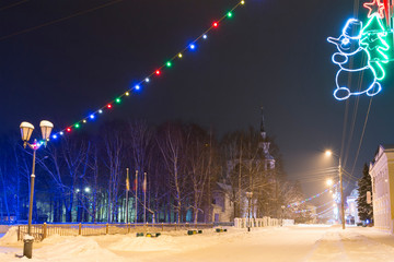 Night winter view of the christmas decorated Sovetsky prospect (Soviet avenue) in Veliky Ustyug, Vologda Region, Russia.