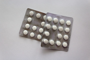 Plate of pills on white background