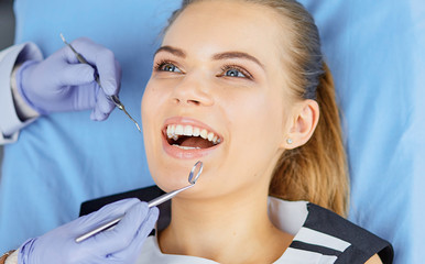 beautiful girl in the dental chair on the examination at the de