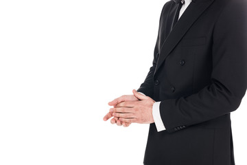 Obraz na płótnie Canvas cropped view of man posing in black elegant tuxedo isolated on white