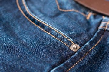 Fototapeta premium Blue jeans fabric macro seam pattern blurred background