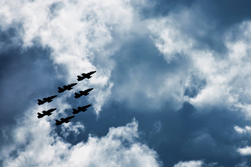 Menacing siueti military aircraft in a cloudy sky