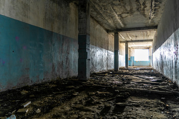 Fototapeta na wymiar Hall of an abandoned building in the dark