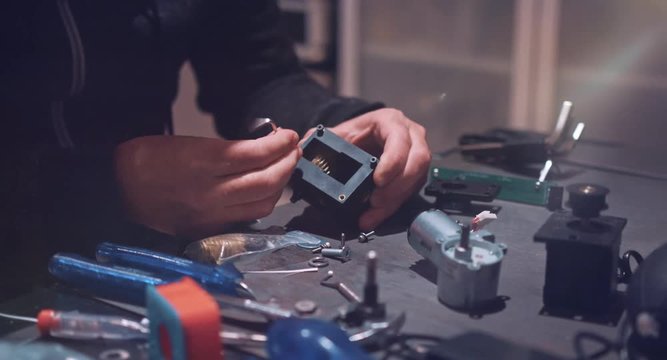 Factory Engineer Operating on cogwheel in gearbox, develop new transmission technology