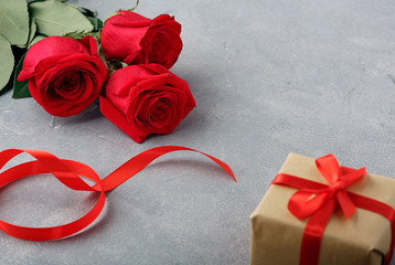 Valentine's Day, Gift box of kraft paper with a red ribbon and red roses.