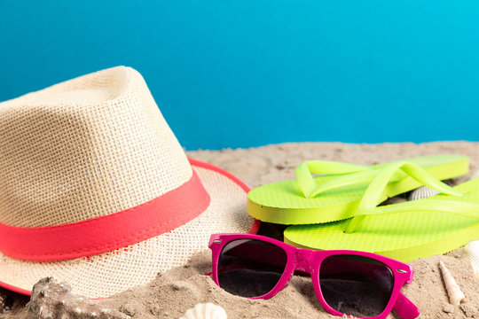 flip flops with sunglasses and strand hat