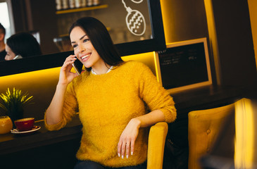 Portrait of smiling young woman talking on cellphone