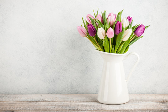 Fresh colorful tulips in a jug