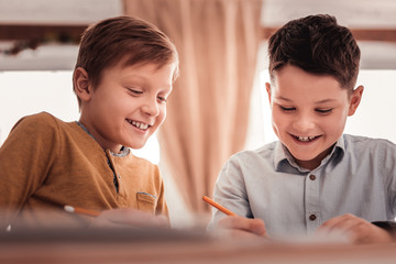 Two adopted children smiling broadly while communicating