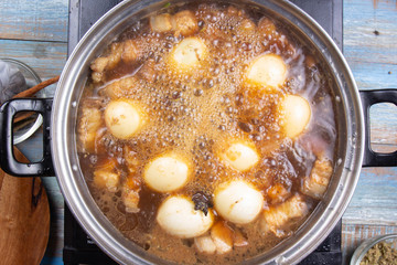 Chef cooking streaky pork in pot