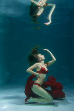 Pretty Caucasian Long Hair Woman Swimming Underwater In Red Sexy Lingerie Alone In The Deep