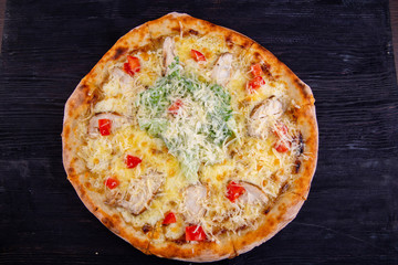 Chicken breasts, grated cheese and lettuce leaves pizza