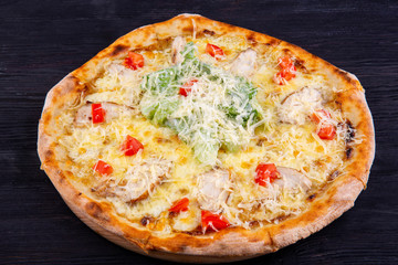 Chicken breasts with creamy sauce and grated cheese on pizza
