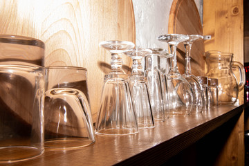 Glass glasses on a rack with trays and a jug