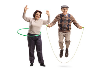 Elderly woman with a hula hoop and a senior man jumping with a skipping rope