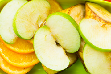 School lunch box. Bread, orange, baby corns, carrot and tomatoes in green plastic container