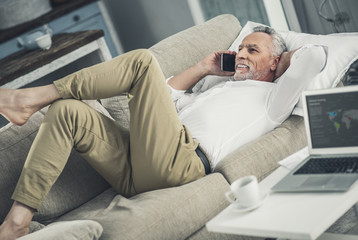 Fototapeta premium Businessman relaxing while lying on sofa
