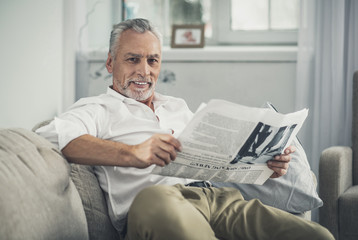 Stylish handsome man reading newspaper
