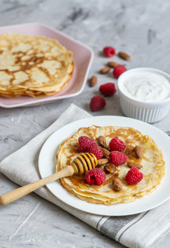 Homemade Pancakes with Raspberry, Almond Nuts and Honey Easy Food Concept Breakfast 