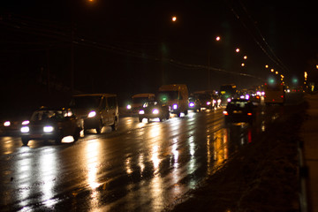 Loaded with cars by city road in the evening