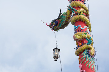 dragon statue on pillar with light lantern