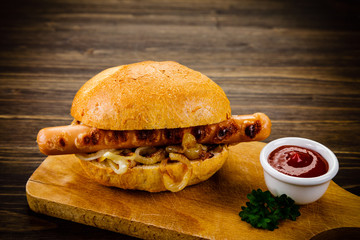 Bun with sausage on cutting board