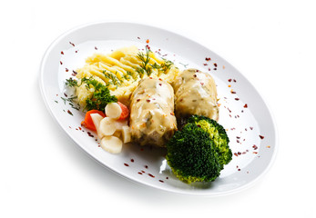 Roast meatballs with mashed potatoes and broccoli on white background