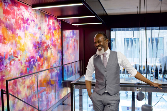 Senior black businessman laughing in a contemporary office