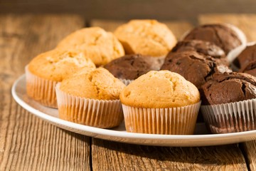 Chocolate cake and nut cake, homemade cakes on wooden background