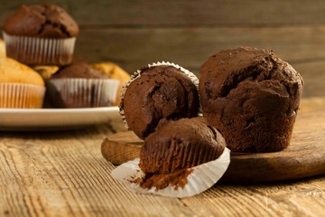 Chocolate muffin, homemade pastry on a wooden background close-up in rustic style