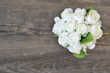 Bouquet of white roses on a wooden vintage background. Element of a greeting holiday card.