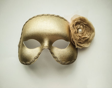 One golden mask with flower on white fone