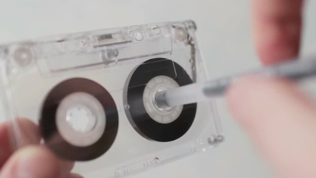 Man manually rewind a cassette tape