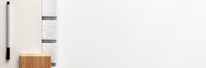 Creative desk with office supplies. Notebook, sketchpad, felt-tip pen and wooden pad. Copy space for text. Panoramic top view. Minimal and simple