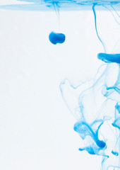 Color drop in water on a white background close-up, abstraction