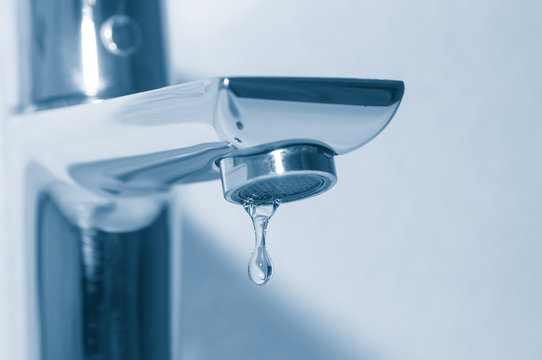 Faucet and water drop close up