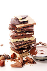 Chocolate bars on table with chocolate tower.
