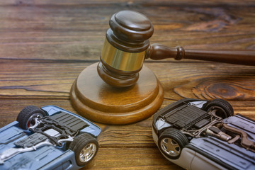 hammer judges, inverted cars on wooden background. court. claim.damnification.